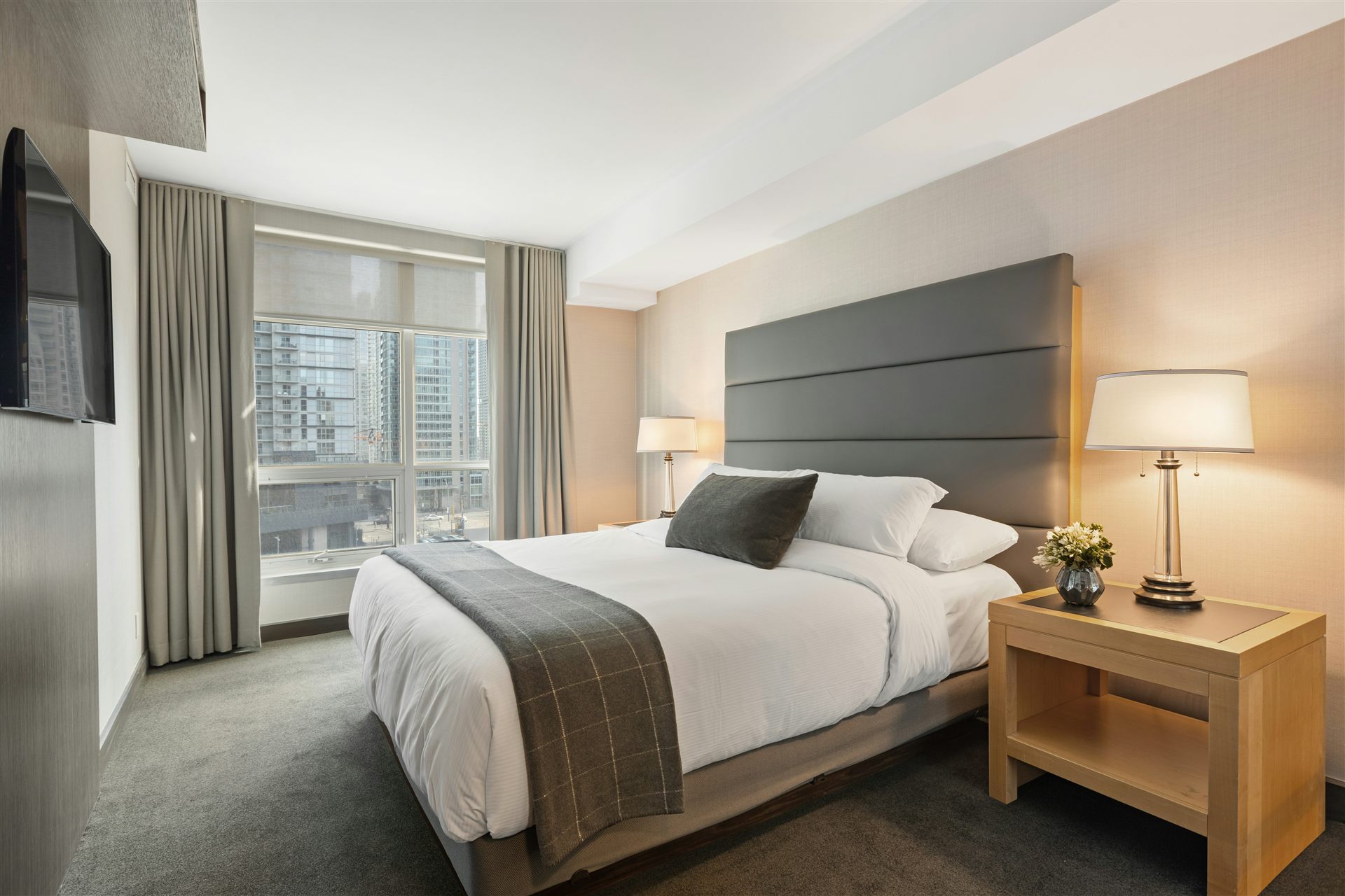 Hotel room with bed and wall-mounted television